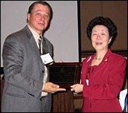 Doreen Chen with award and Gene Bruno. - Copyright – Stock Photo / Register Mark