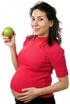 Pregnant woman holding an apple. - Copyright – Stock Photo / Register Mark