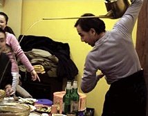 Harvey Brenton serves tea over his shoulder using long necked teapot. - Copyright – Stock Photo / Register Mark