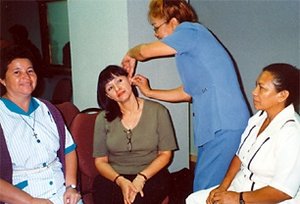 Participating doctors and nurses practice the NADA five-needle protocol. - Copyright – Stock Photo / Register Mark