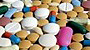 A spill of pills and vitamins. - Copyright – Stock Photo / Register Mark