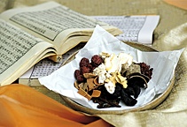 A bowl of herbs on top of Oriental Medicine textbooks. - Copyright – Stock Photo / Register Mark