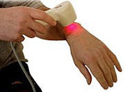 Therapist using low-level laser therapy on his wrist. - Copyright – Stock Photo / Register Mark