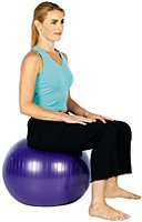 Woman sitting on exercise ball. - Copyright – Stock Photo / Register Mark