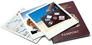 A pile of poloroid pictures and a passport. - Copyright – Stock Photo / Register Mark