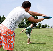 Two men playing frizbee. - Copyright – Stock Photo / Register Mark