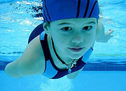 Young girl swimming underwater. - Copyright – Stock Photo / Register Mark