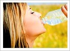 Woman drinking from water bottle. - Copyright – Stock Photo / Register Mark
