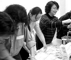 Aileen Huang leads attendees in a dumpling-making demonstration. - Copyright – Stock Photo / Register Mark