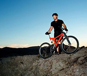 Athlete standing with mountain bike. - Copyright – Stock Photo / Register Mark